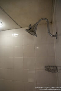 a shower head on a tile wall