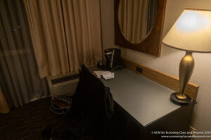 a desk with a mirror and a coffee machine