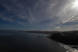 a body of water with a city in the background