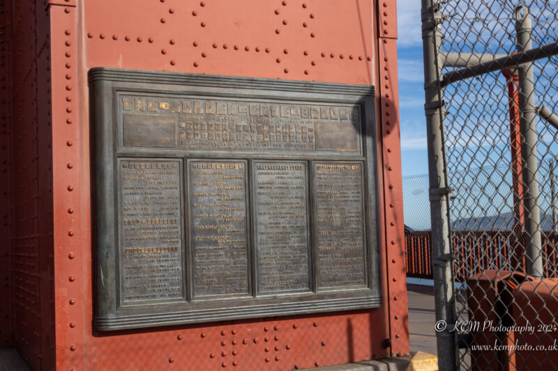 a metal plaque on a red wall