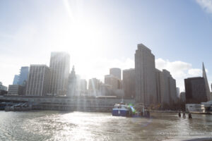 a boat in a body of water with a city in the background