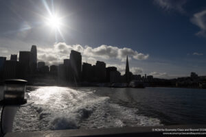 a city skyline with a boat behind it