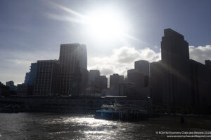 a city skyline with a ferry in the water
