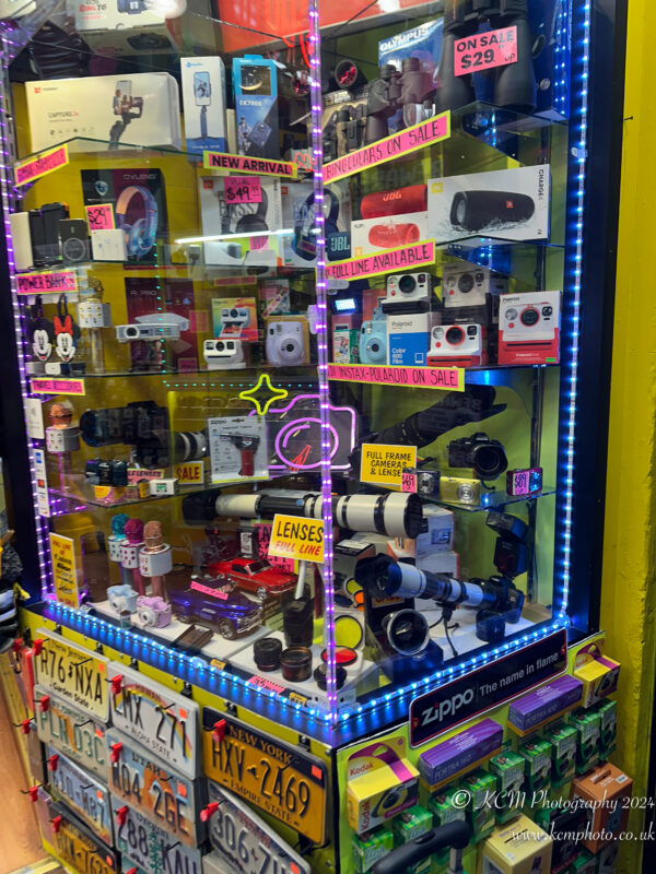 a display case with cameras and other items