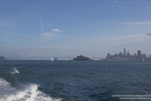 a body of water with a city in the background
