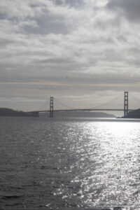 a bridge over water with a body of water and a cloudy sky