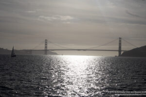 a bridge over water with a body of water and a bridge in the background