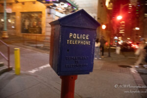 a blue telephone box on a street