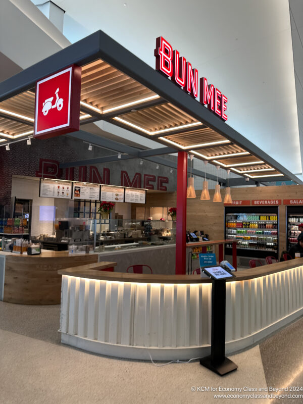 a food court with a red sign
