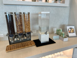 a group of cereals and a water dispenser on a counter