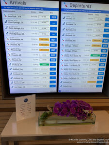 a screen with a sign and flowers