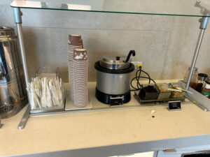 a counter with a container and a container of paper cups