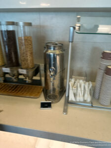 a group of containers of cereal and a phone on a counter