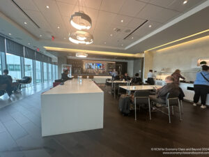 a group of people sitting at tables in a room with windows