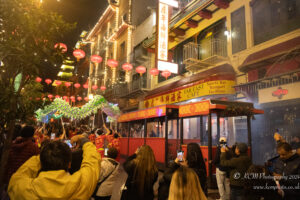 a group of people standing in front of a street with a sign
