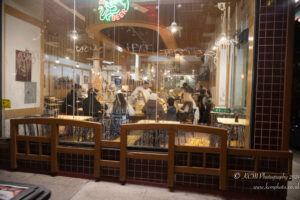 a group of people sitting at tables in a restaurant