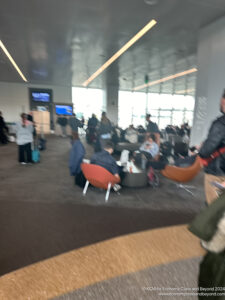 a group of people in a room with chairs