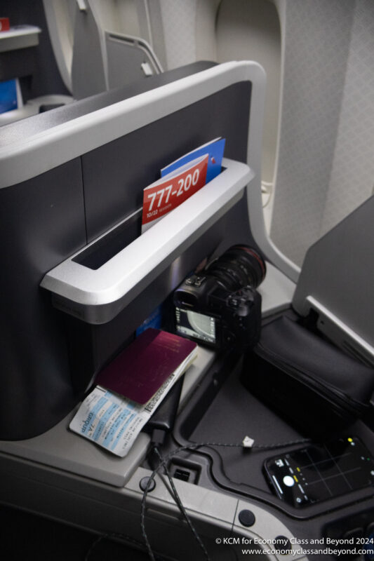 a camera and passport on a seat