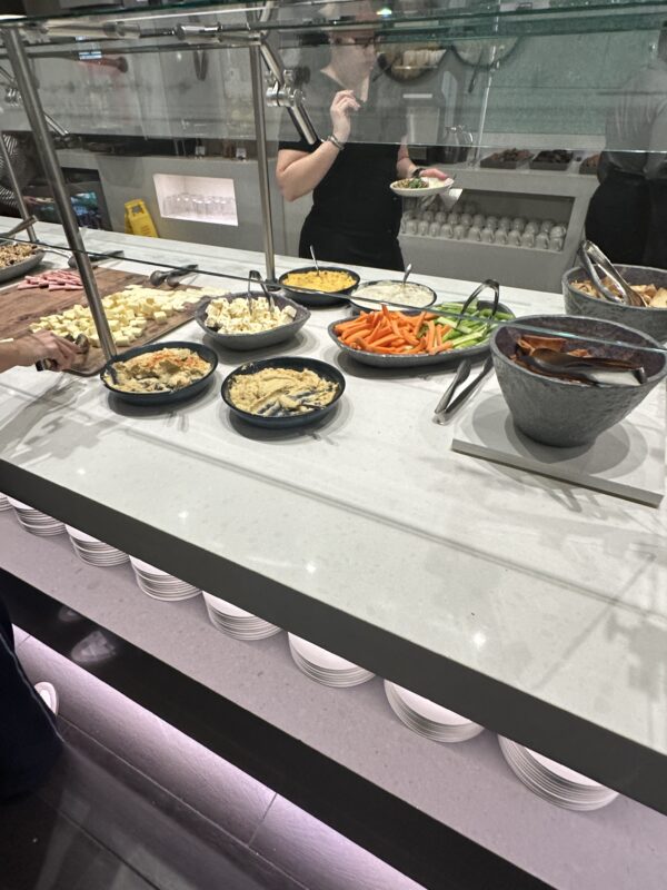 a buffet line with food in bowls