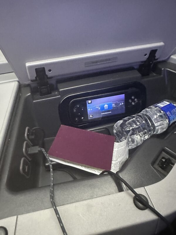a book and a water bottle in a car console