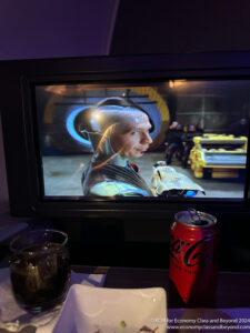a tv screen with a drink and a can of soda