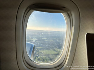 an airplane window with a view of a city