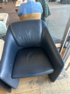 a black leather chair in a room