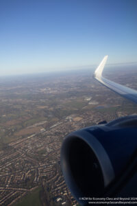 an airplane wing and a city