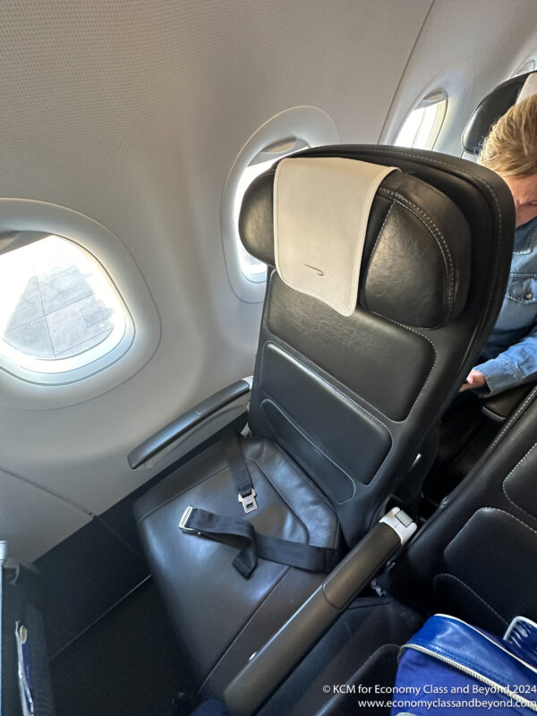 a person sitting in a chair in an airplane