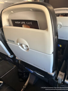 a book in the back of an airplane seat