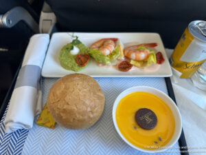 a plate of food and a bowl of soup on a table