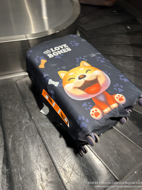 a luggage bag with a cartoon dog on it
