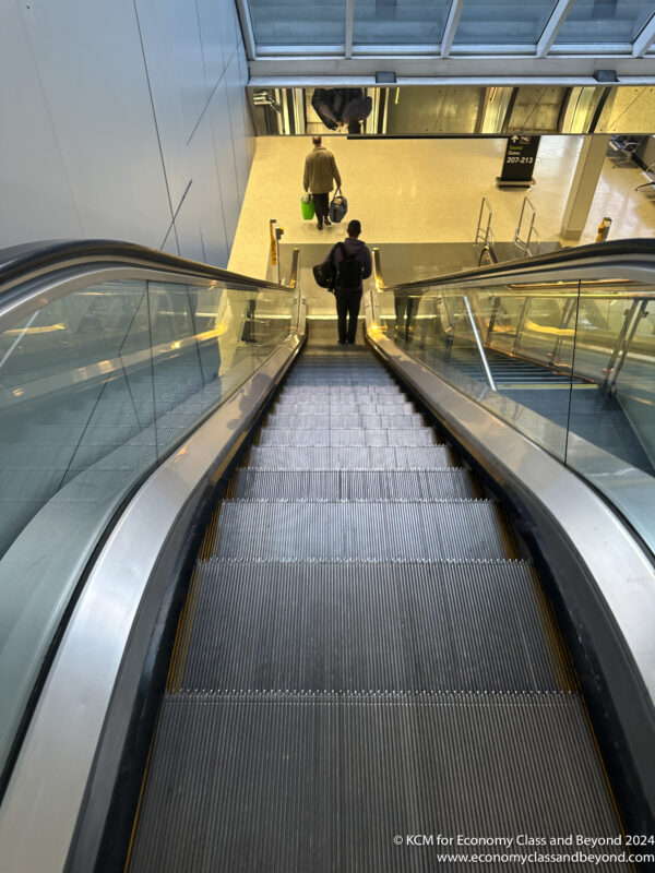 a man standing on an escalator