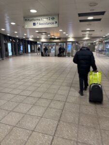 a man walking with luggage in a building
