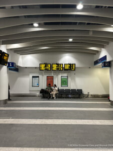 people sitting on a bench in a building