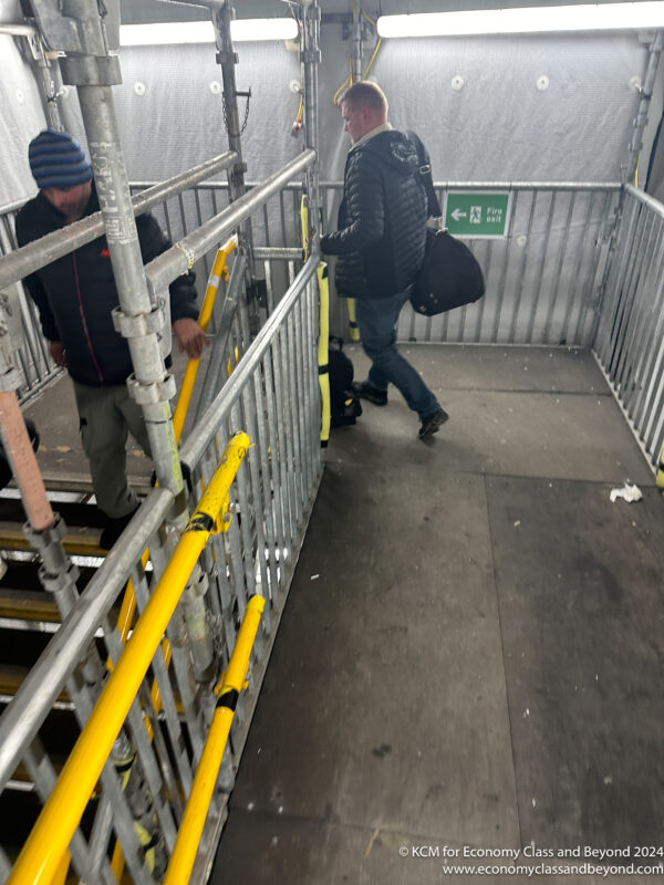 a man walking down a metal staircase