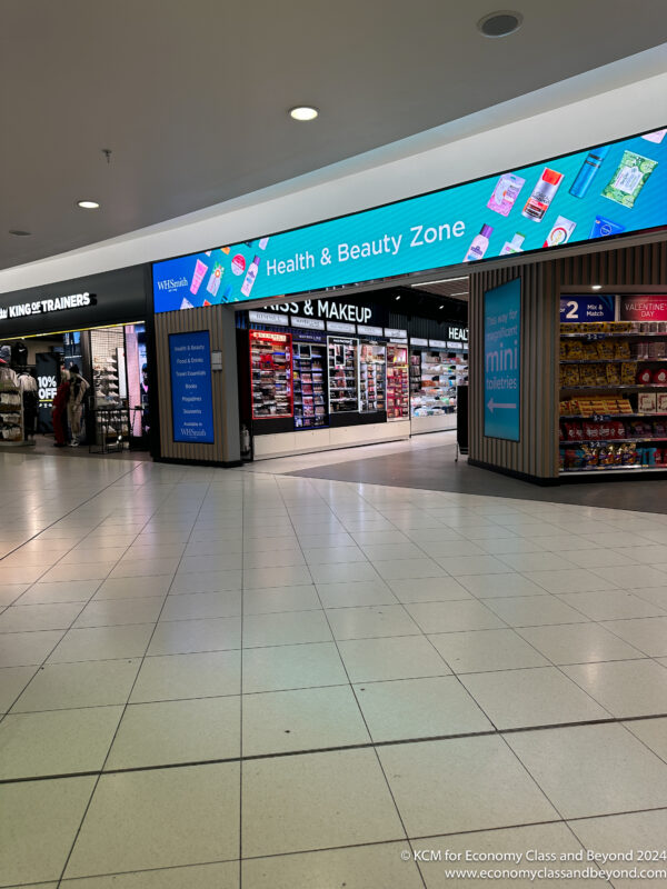a storefront with signs and shelves in a mall