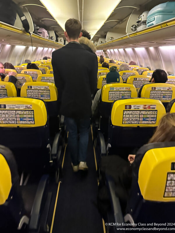 a man walking in an airplane