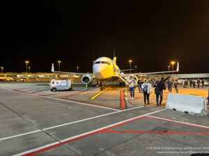 a group of people walking around an airplane