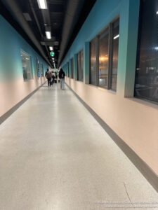 a group of people walking in a hallway