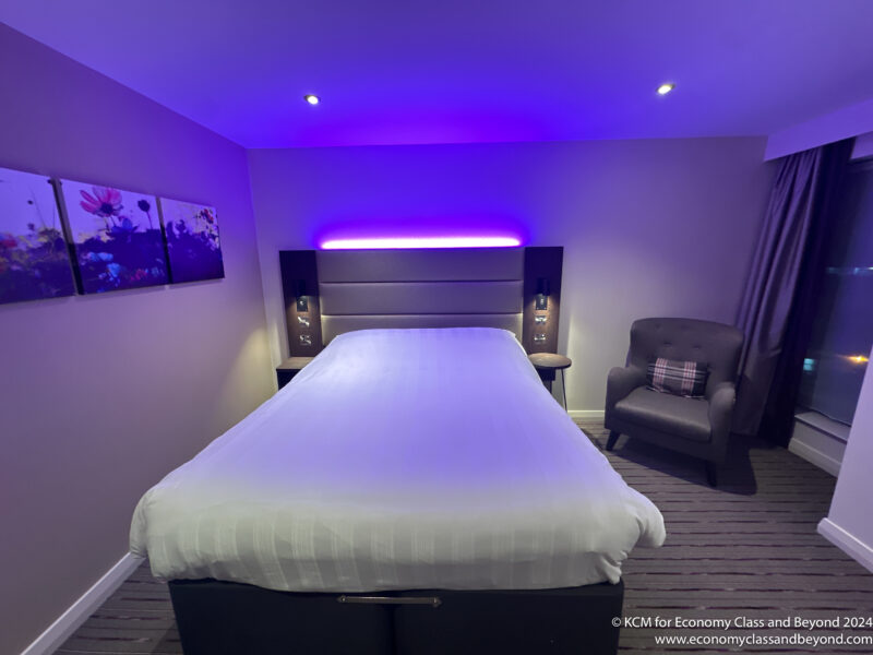 a bed with purple lighting