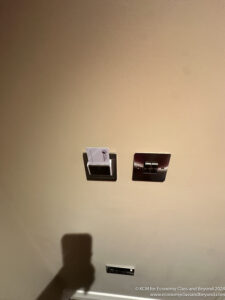 a light switch and a card holder on a wall