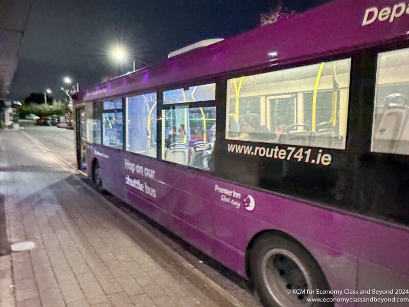 a purple bus parked on a street