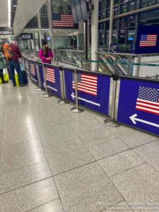 people standing in a line with flags on it