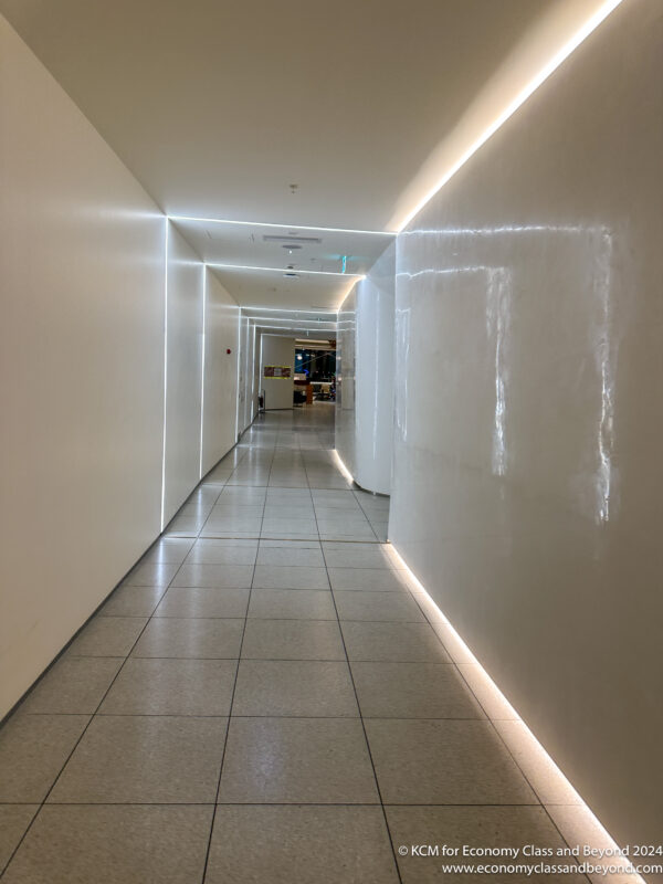 a hallway with white walls and lights