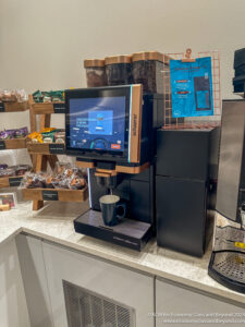 a coffee machine with a screen and coffee beans