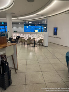 a room with a white wall and chairs