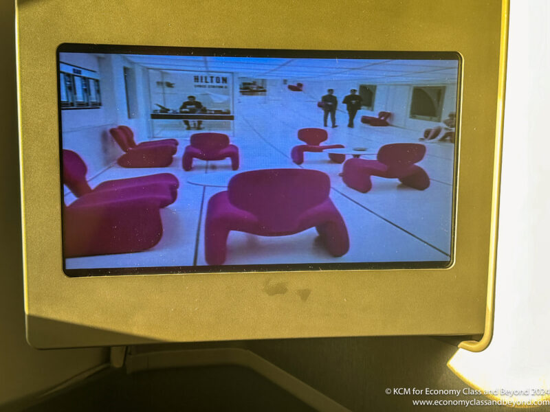 a screen shot of a room with red chairs