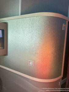 a silver metal box with a red light