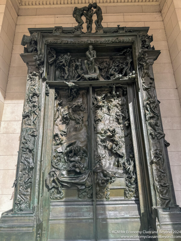 a large ornate door with statues on it